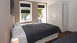 Schlafzimmer Doppelbett und Einzelbett und Zugang zur Terrasse